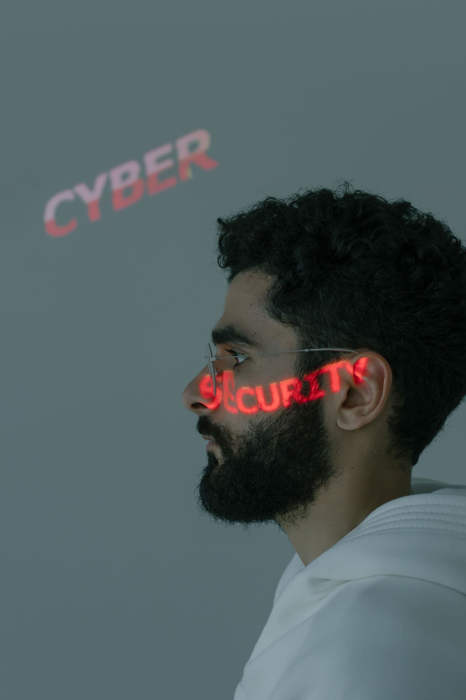 Data center security signage projected across a dim server hall